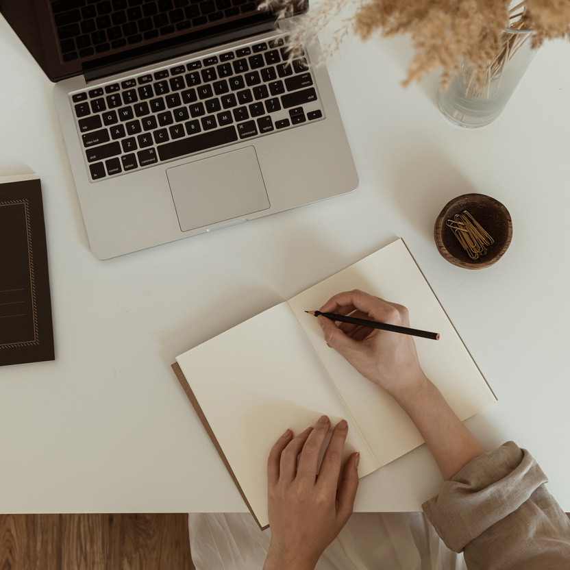 Woman Writing on Notebook